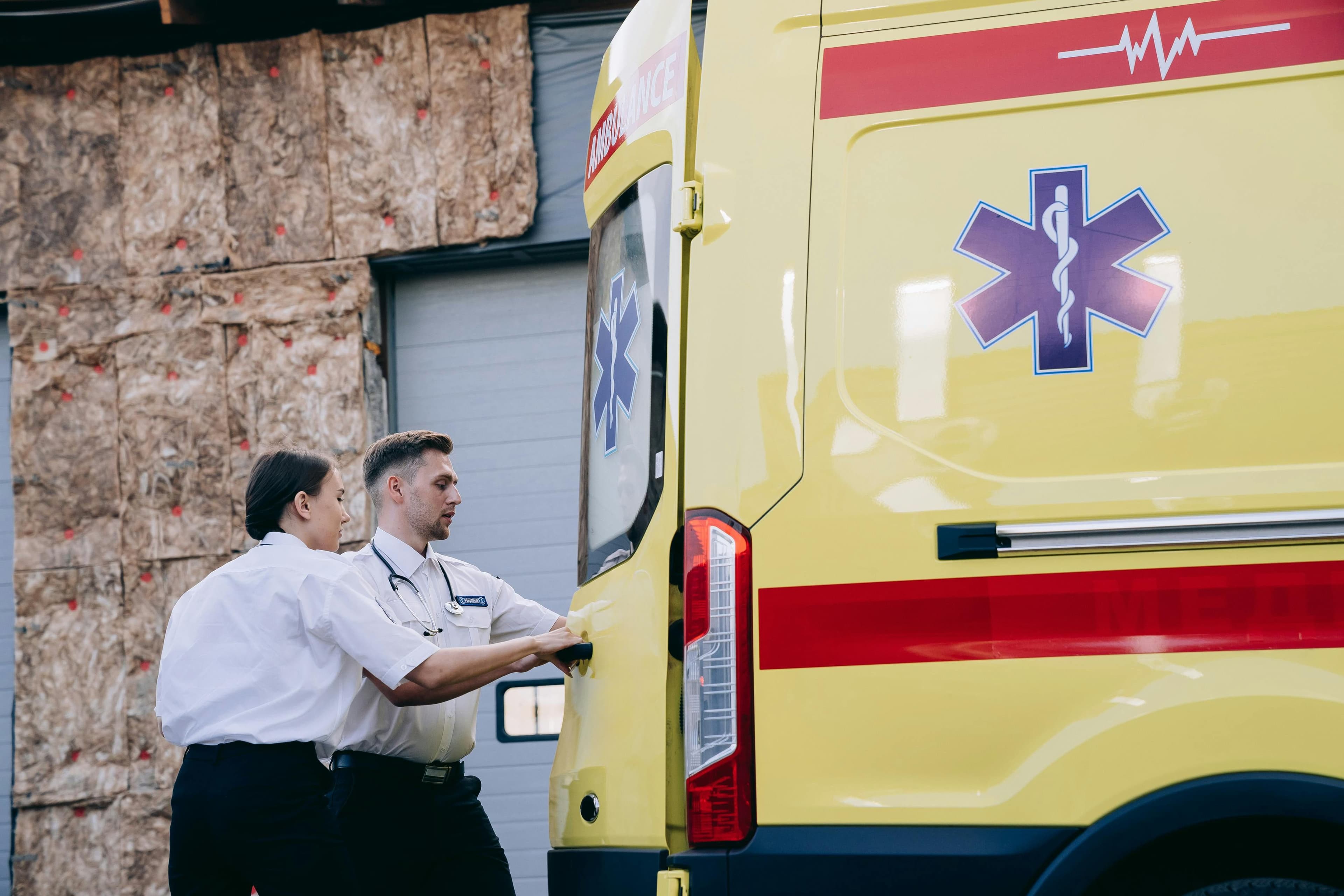 Emergency medical staff preparing an ambulance