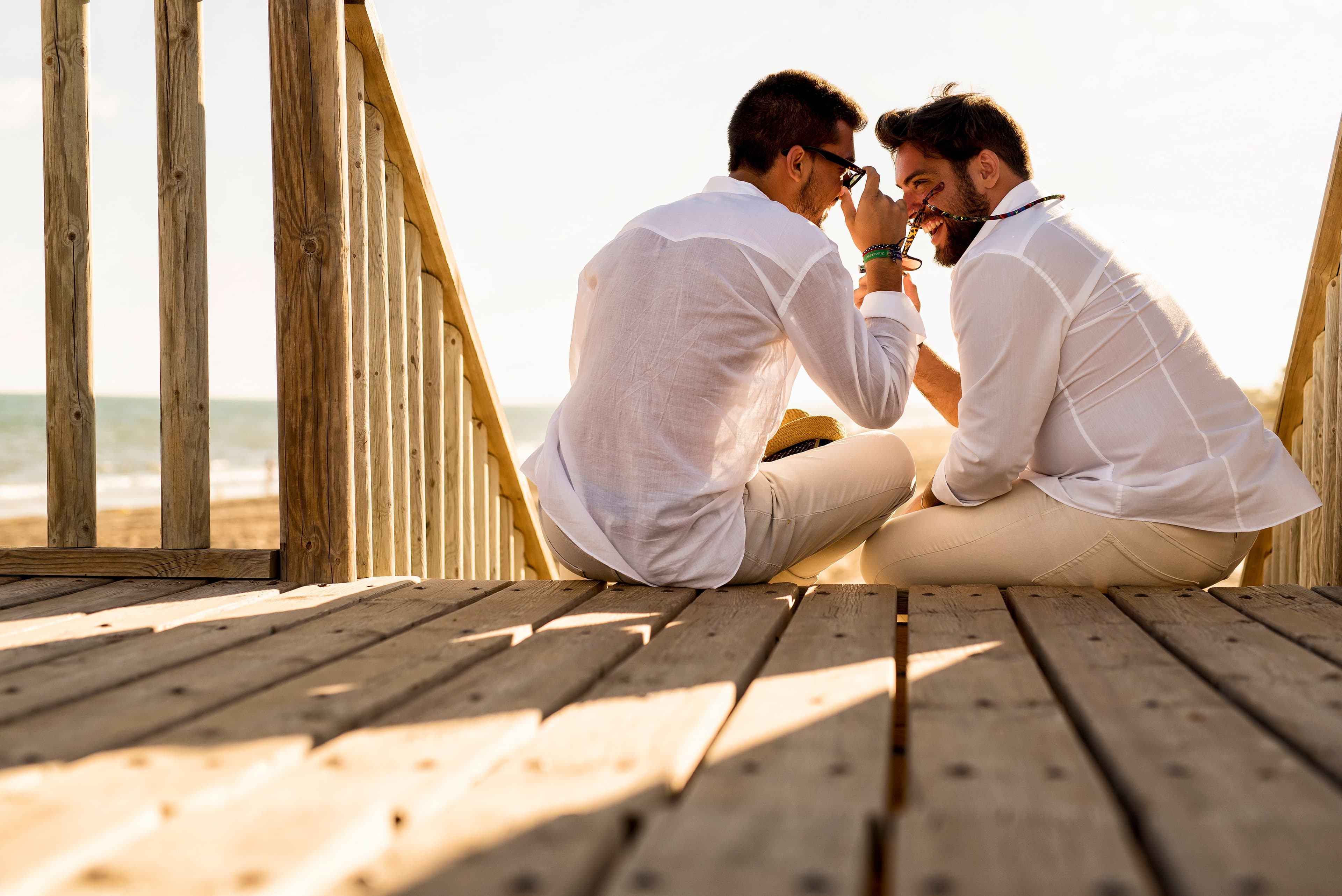 A couple sitting together by the sea