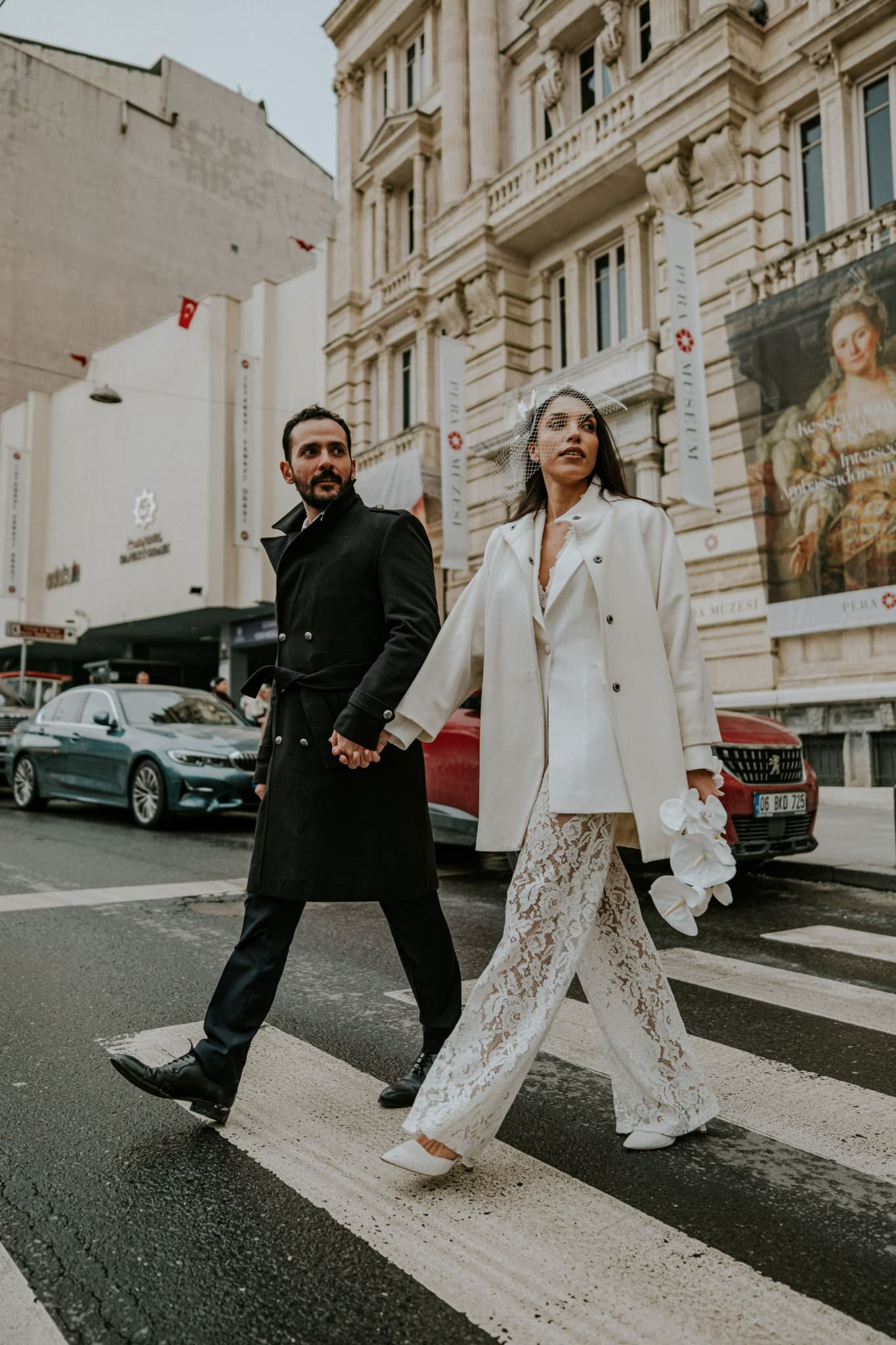 A couple walking through a grand cultural district in a city abroad