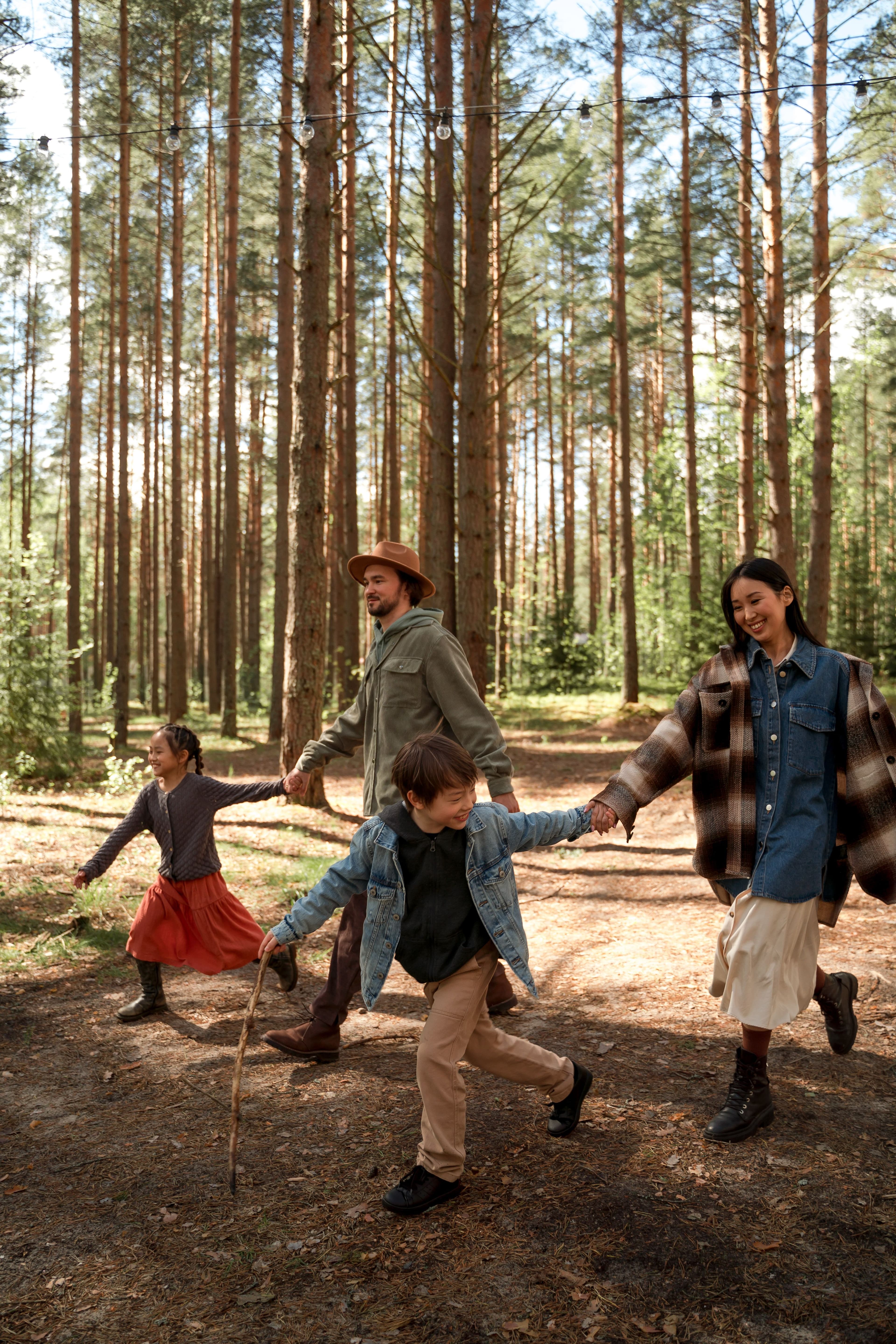 A family running together through a forest