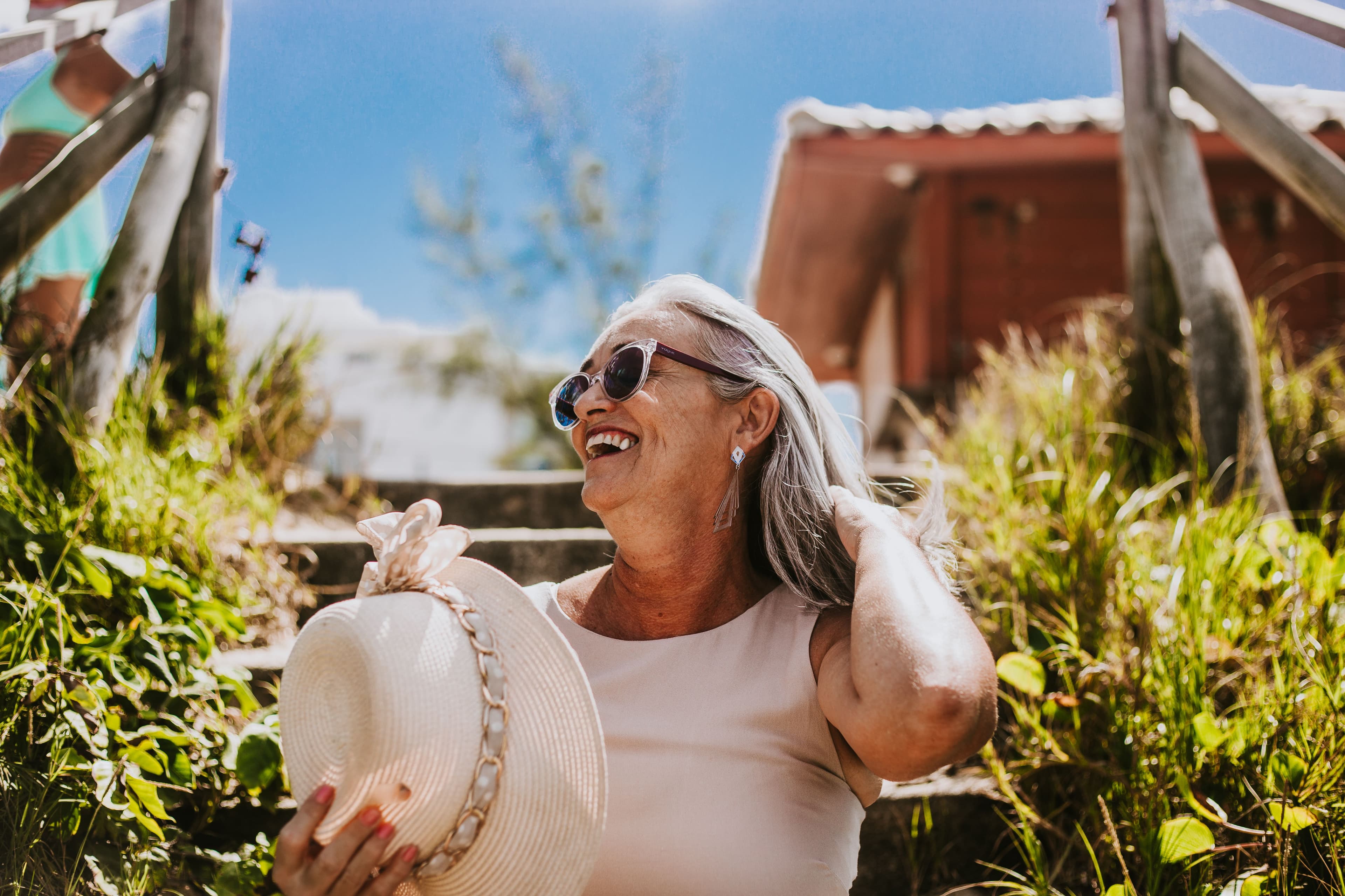 A smiling retiree enjoying a sunny day outdoors